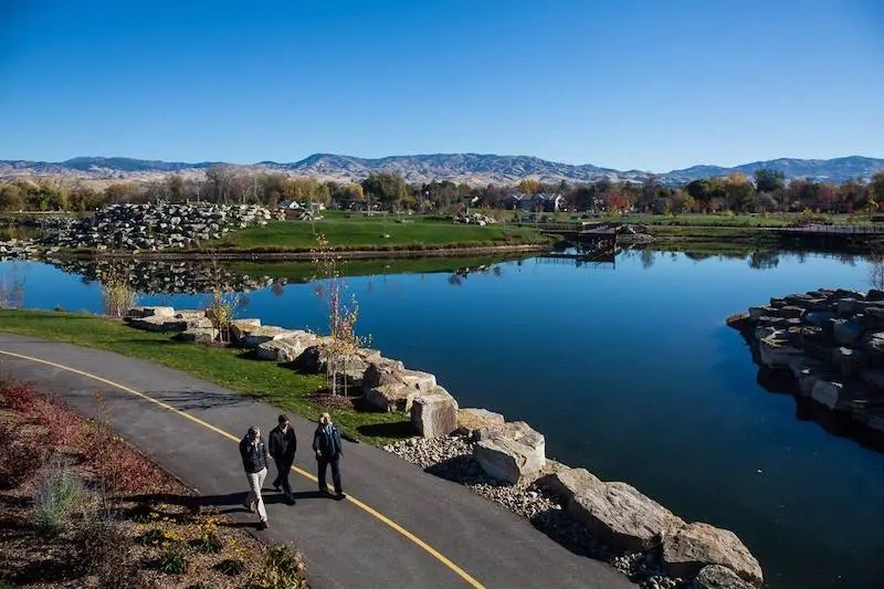 Seniors walking a paved tree-lined stretch of the Boise River Greenbelt in Eagle, Idaho